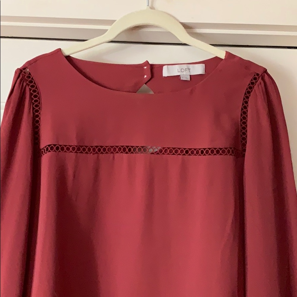 Rust colored blouse with cutout design